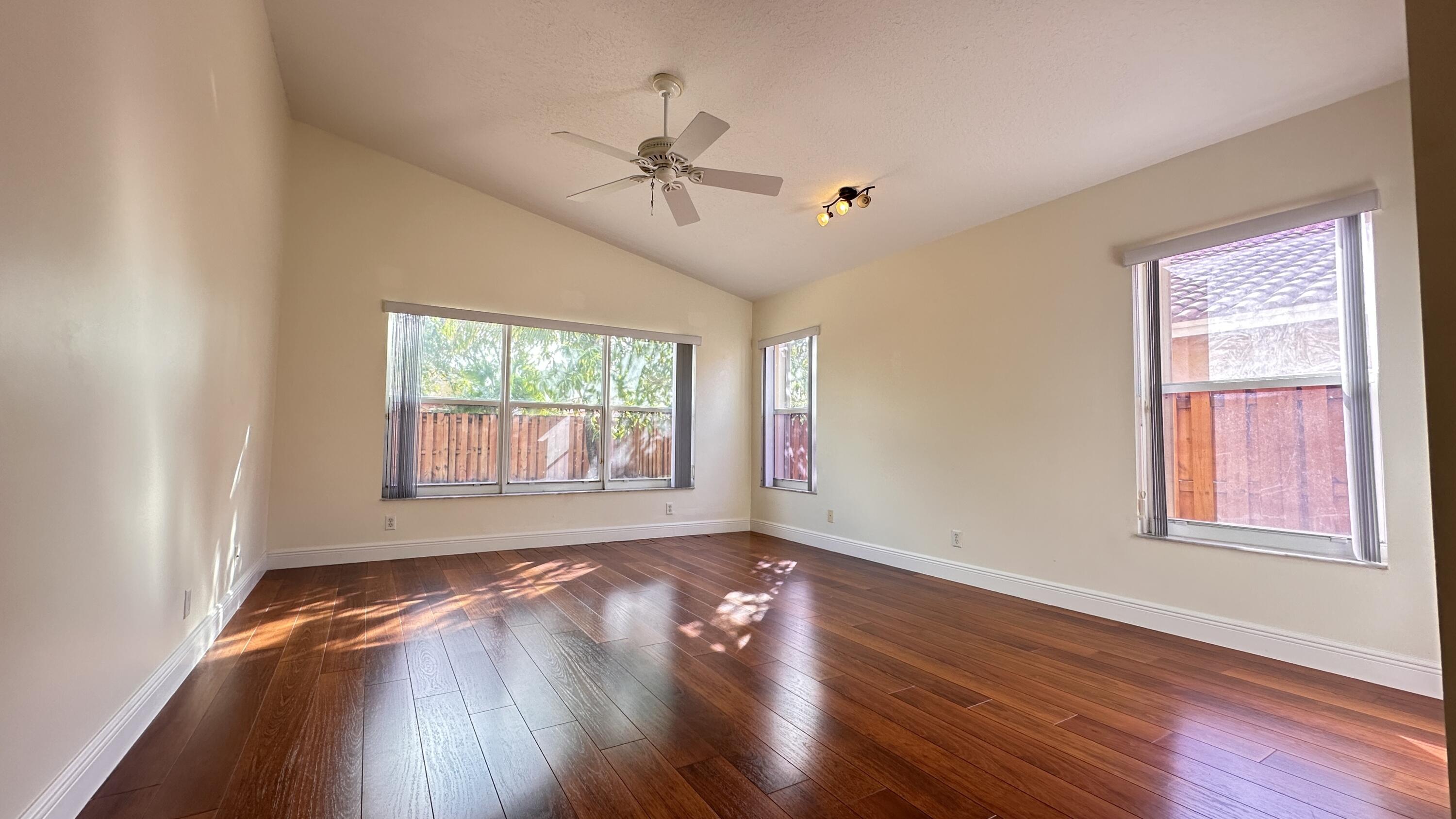 19010 Southwest 10th Street Pembroke Pines, FL 33029 - Photo 32 of 59 a view of an empty room with wooden floor and a window