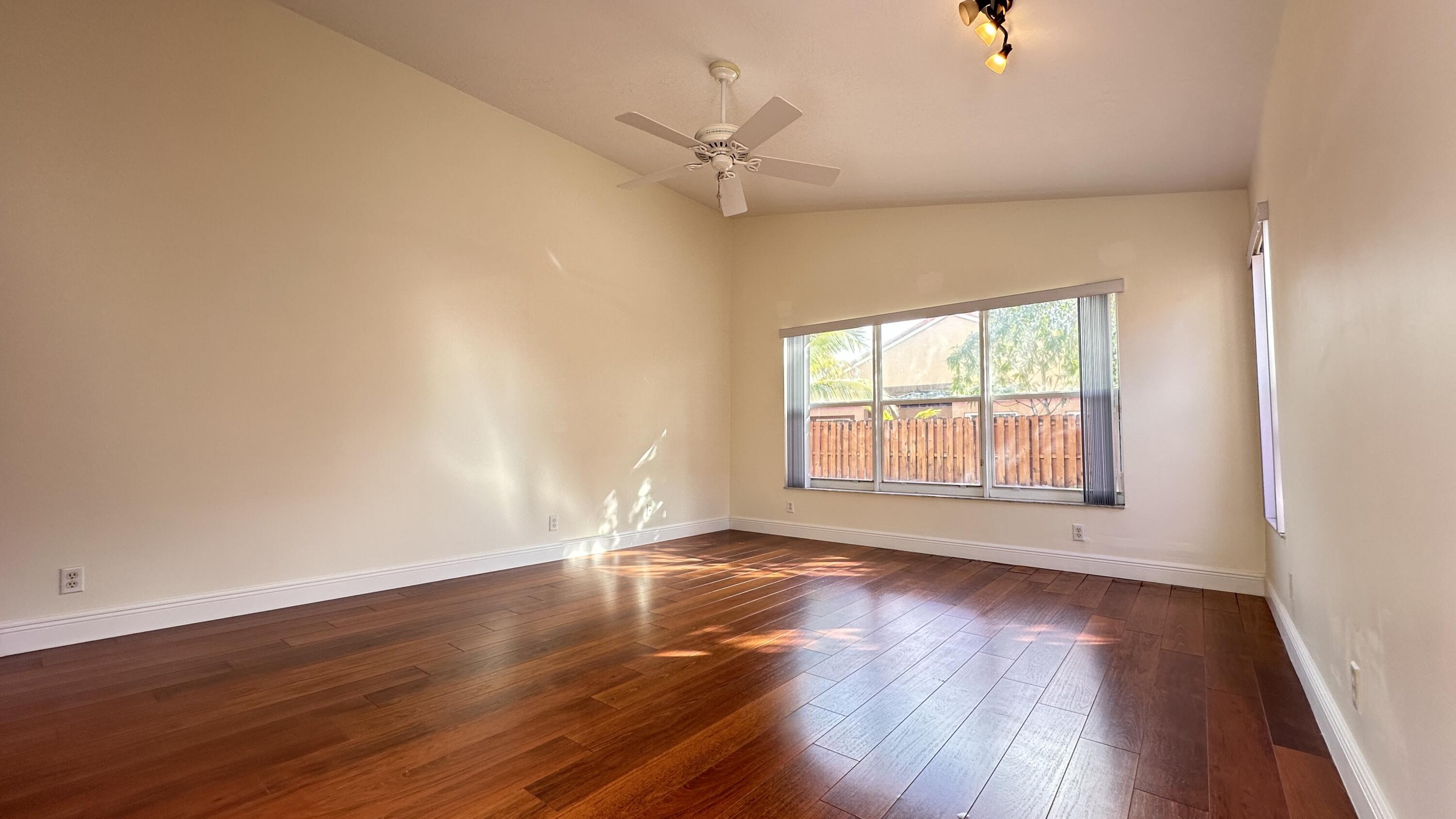 19010 Southwest 10th Street Pembroke Pines, FL 33029 - Photo 35 of 59 an empty room with wooden floor fan and windows