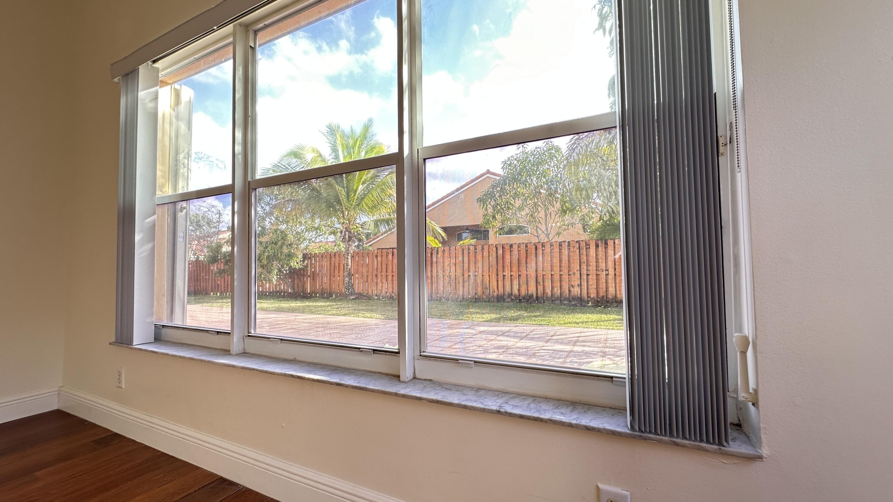 19010 Southwest 10th Street Pembroke Pines, FL 33029 - Photo 36 of 59 a view of a room with wooden floor and a porch