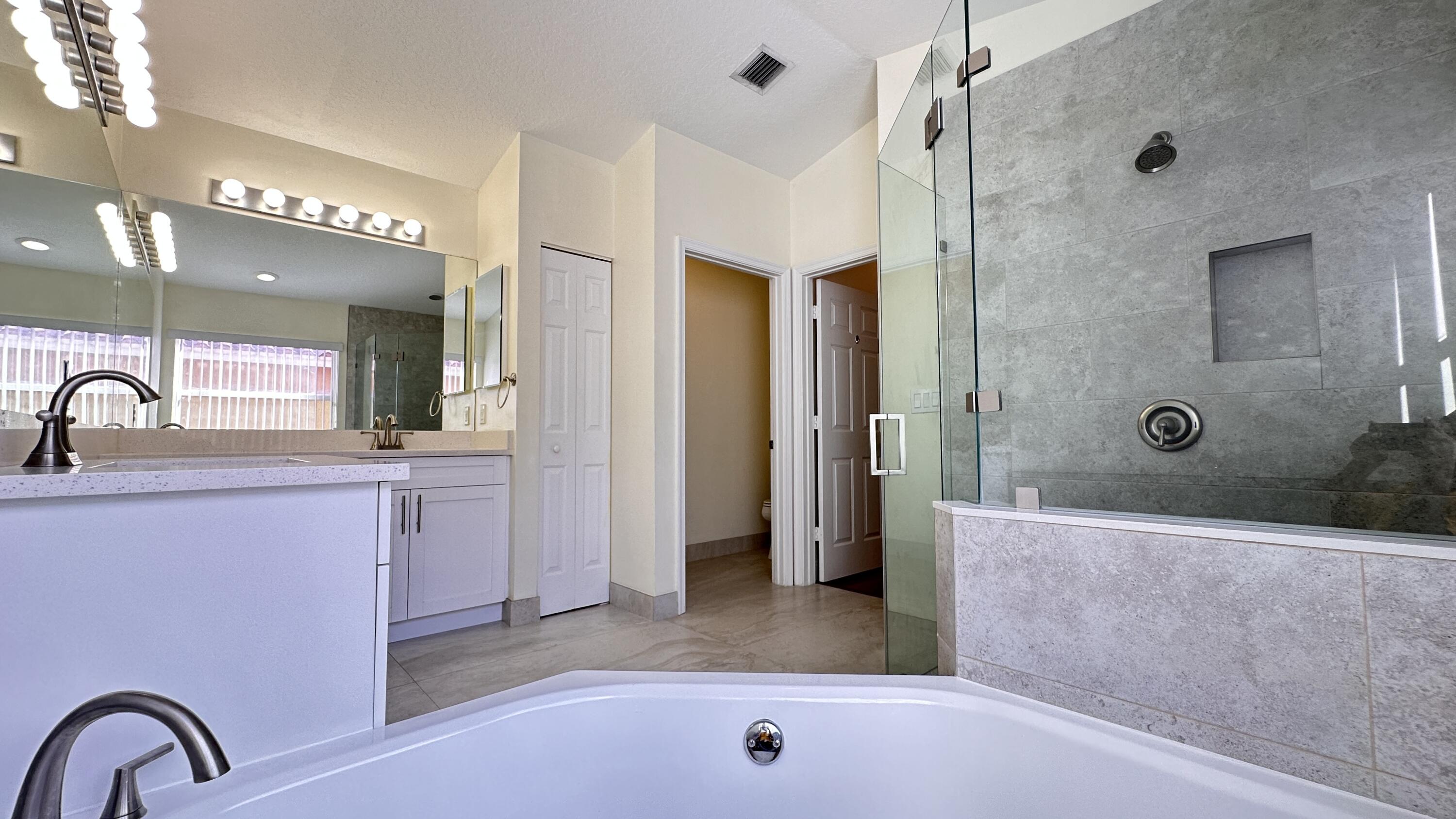 19010 Southwest 10th Street Pembroke Pines, FL 33029 - Photo 41 of 59 a bathroom with a sink a shower a mirror and bathtub