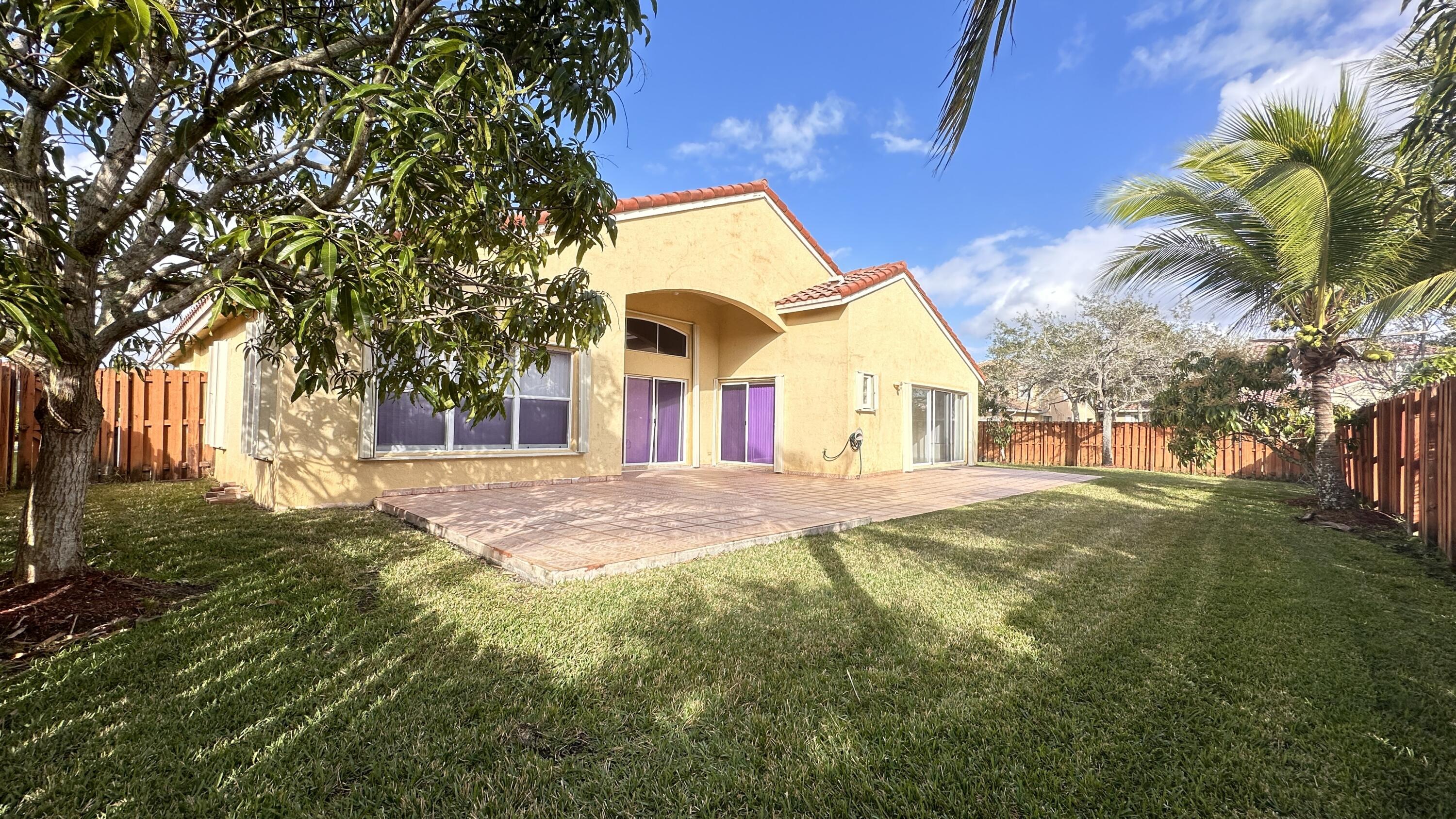 19010 Southwest 10th Street Pembroke Pines, FL 33029 - Photo 49 of 59 a front view of a house with a yard
