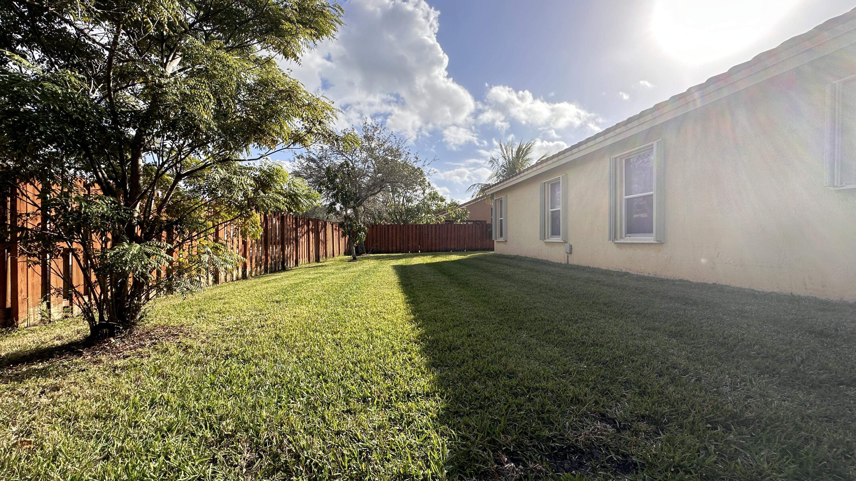 19010 Southwest 10th Street Pembroke Pines, FL 33029 - Photo 52 of 59 a view of a backyard with large trees