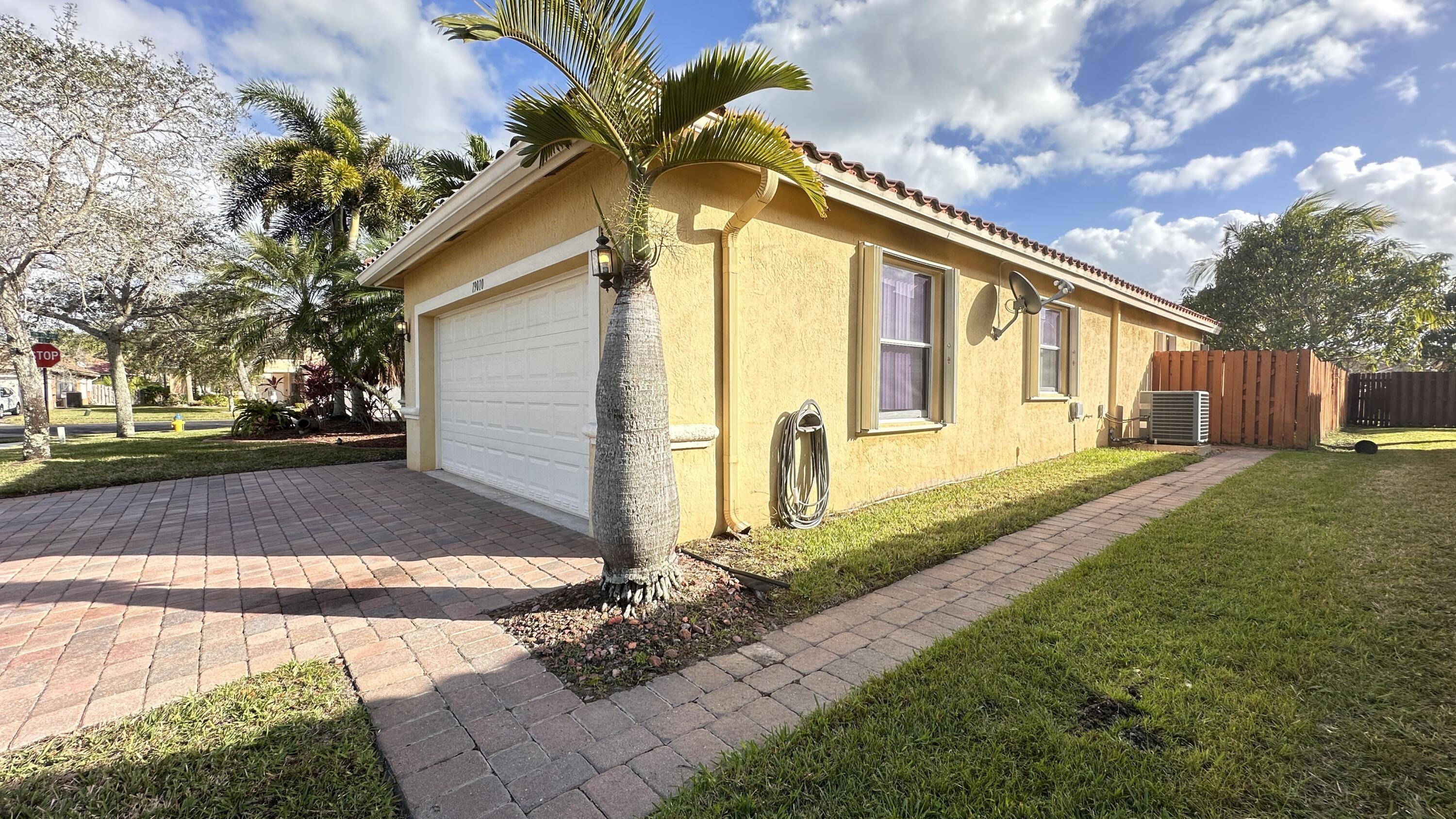 19010 Southwest 10th Street Pembroke Pines, FL 33029 - Photo 54 of 59 a front view of a house with a yard