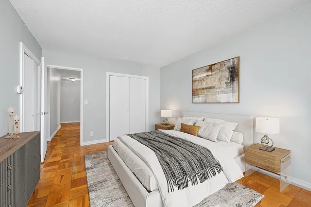 a bedroom with a bed and a lamp