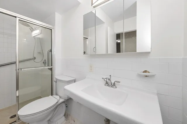 a bathroom with a sink toilet and shower