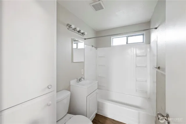 a bathroom with a shower a toilet and sink