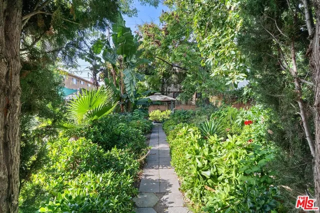a view of a chairs and tables in the patio and a fountain