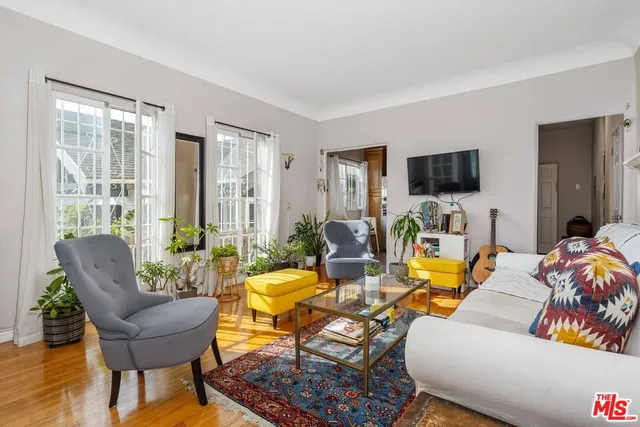 a living room with furniture and a potted plant