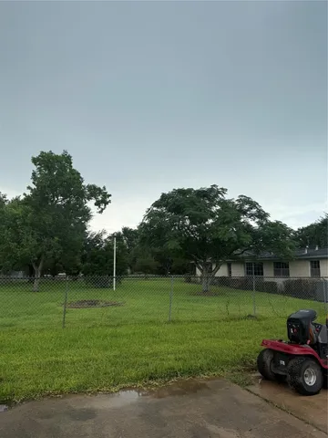a backyard of a house with lots of green space and fountain