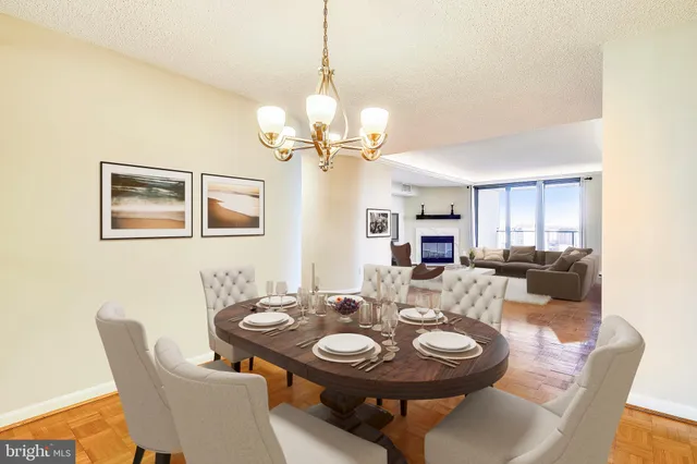 a view of a room with a cabinet and chandelier