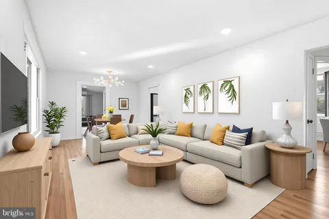 a living room with furniture a rug and a painting