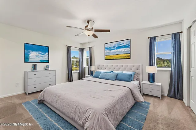 a bedroom with a bed and a tv on dresser