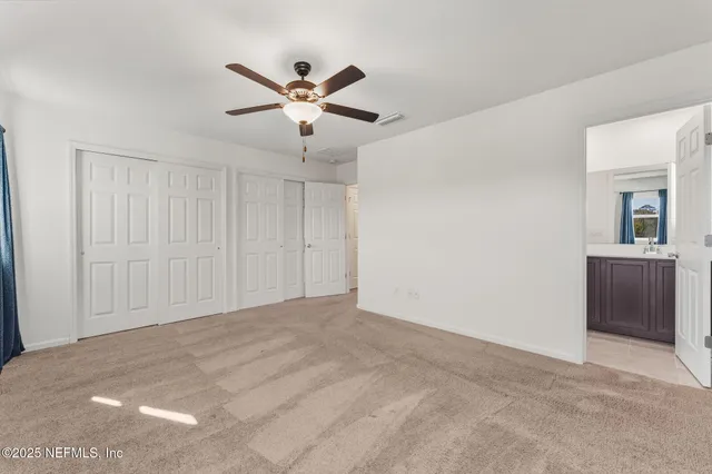 a view of a livingroom with a ceiling fan and window