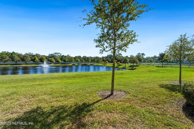 a view of a lake with houses in the background