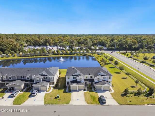 an aerial view of a house with a swimming pool