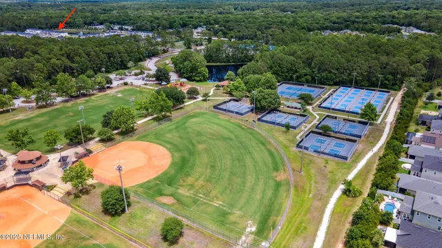 an aerial view of a house with a yard and lake view