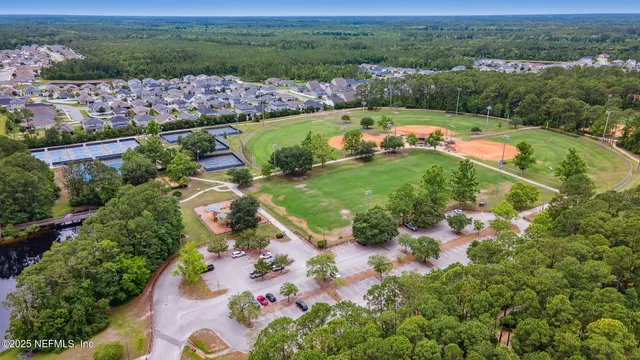an aerial view of swimming pool with outdoor seating