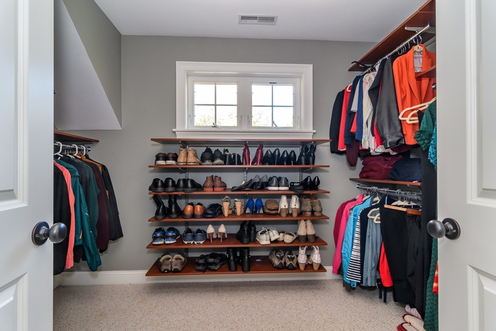 11 Leighton Street Natick, MA 01760 - Photo 17 of 27 a view of walk in closet with clothes and shoes