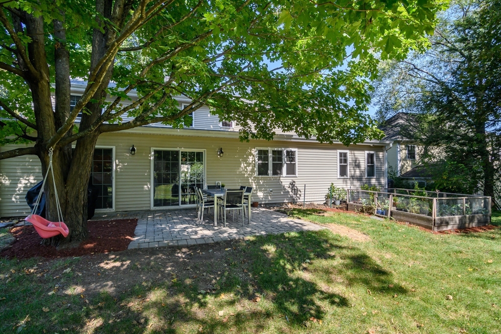 11 Leighton Street Natick, MA 01760 - Photo 24 of 27 a backyard of a house with table and chairs