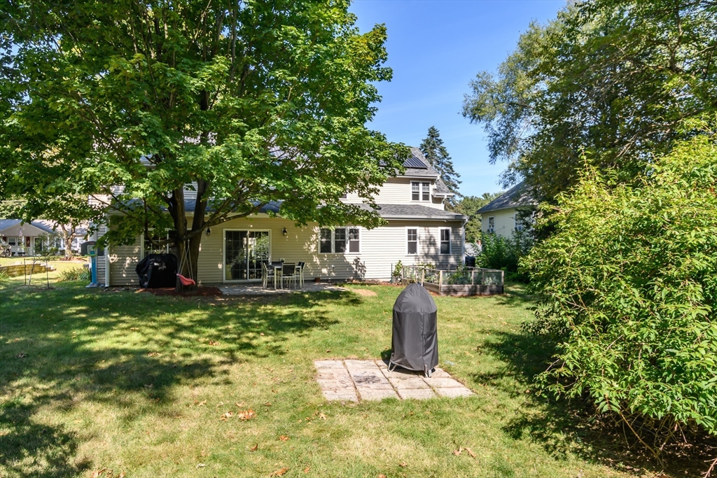 11 Leighton Street Natick, MA 01760 - Photo 26 of 27 a front view of a house with a garden and trees