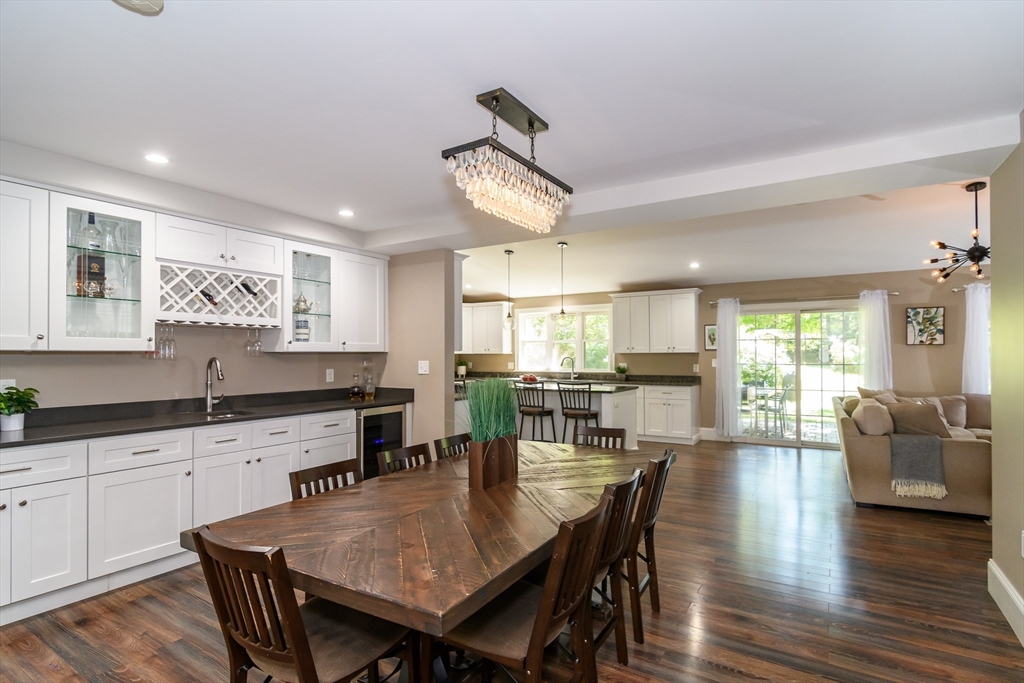 11 Leighton Street Natick, MA 01760 - Photo 3 of 27 a kitchen with granite countertop a table chairs stove and wooden floor