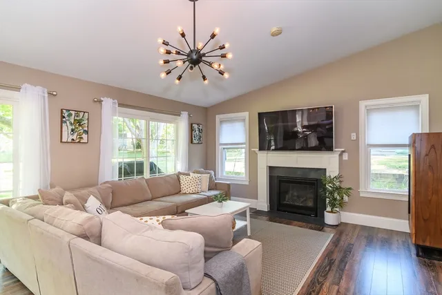 a living room with furniture fireplace and window
