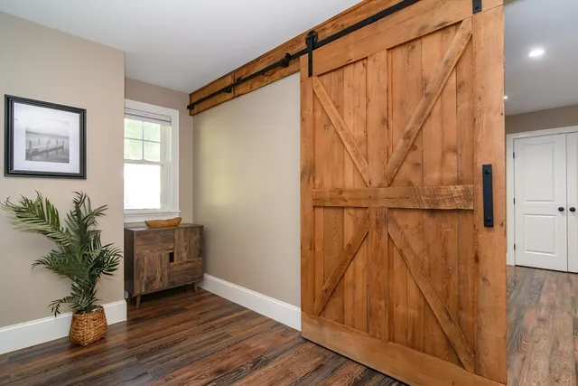 a view of a entryway with wooden floor and cabinet
