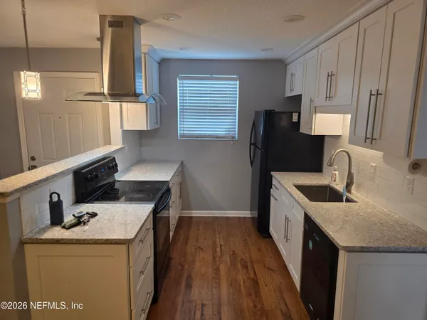 a kitchen that has a sink and a stove in it