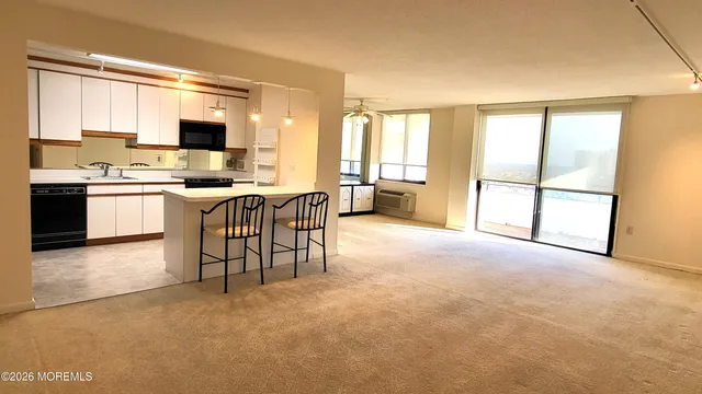 a view of kitchen with furniture and large window