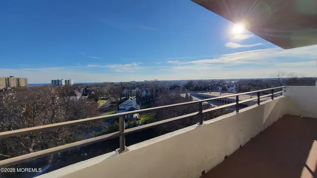 a view of a tall building next to a yard