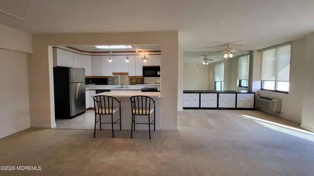a large kitchen with a table and chairs