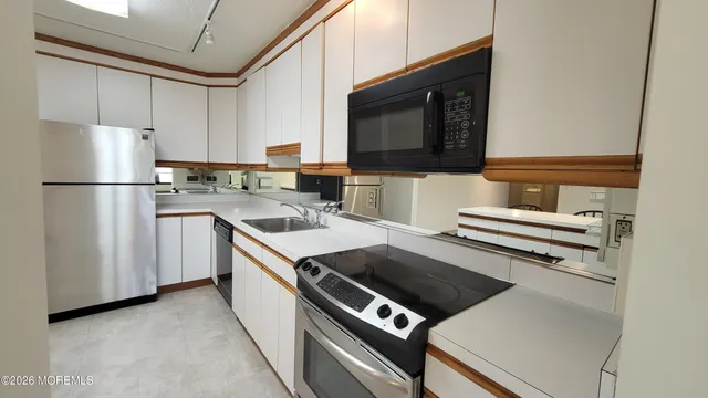 a kitchen with a stove a sink and a refrigerator