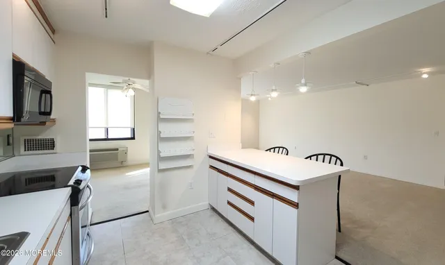 a kitchen with granite countertop a sink stainless steel appliances and cabinets