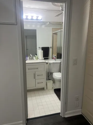 a bathroom with a sink a toilet and mirror