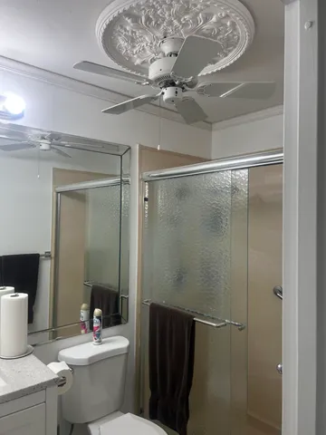 a bathroom with a toilet a sink and shower