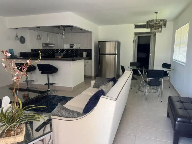 a kitchen with stainless steel appliances a stove a refrigerator and a sink