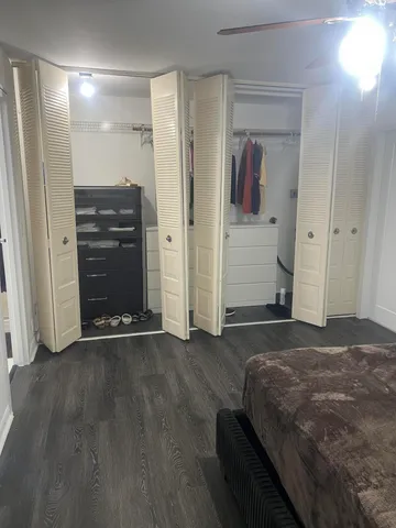 a bedroom with a bed and cabinets