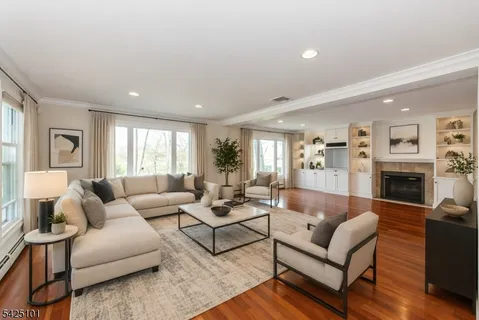 an empty room with wooden floor and fireplace