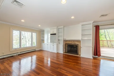 a view of a kitchen cabinets a wooden floor and a window