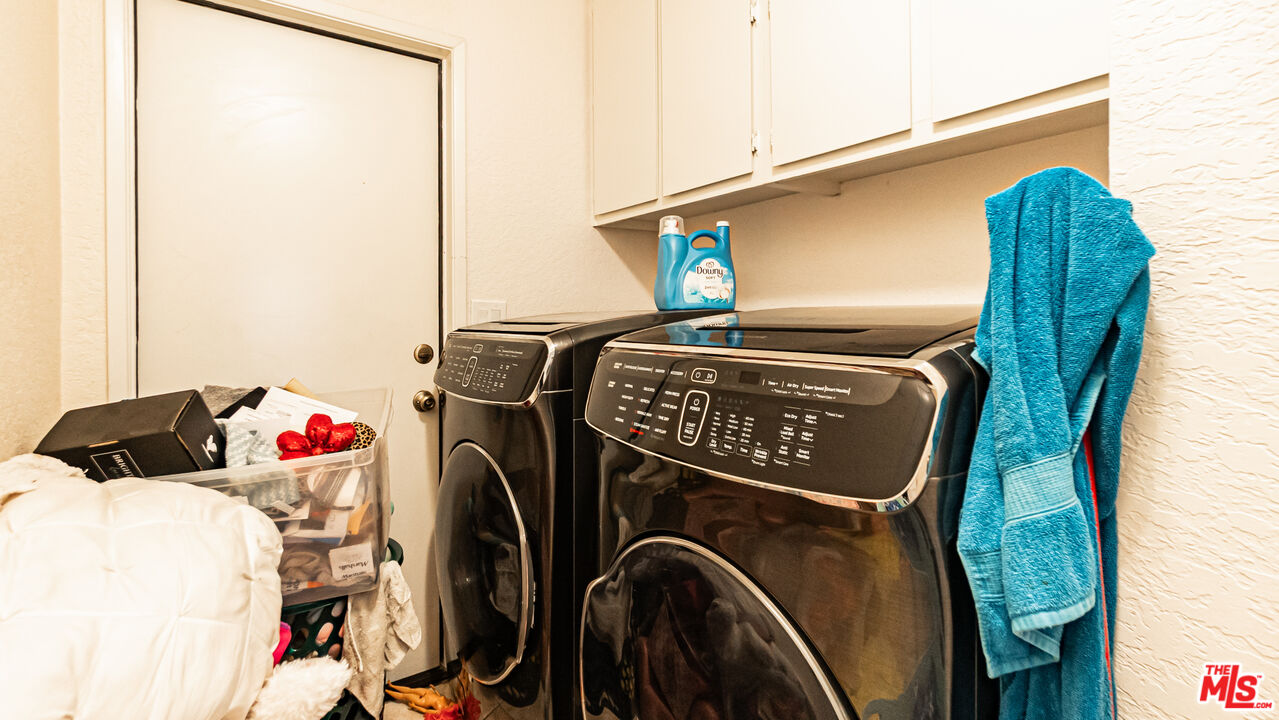 69817 Brookview Way Cathedral City, CA 92234 - Photo 14 of 38 a close view of walk in closet with clothes and shoes