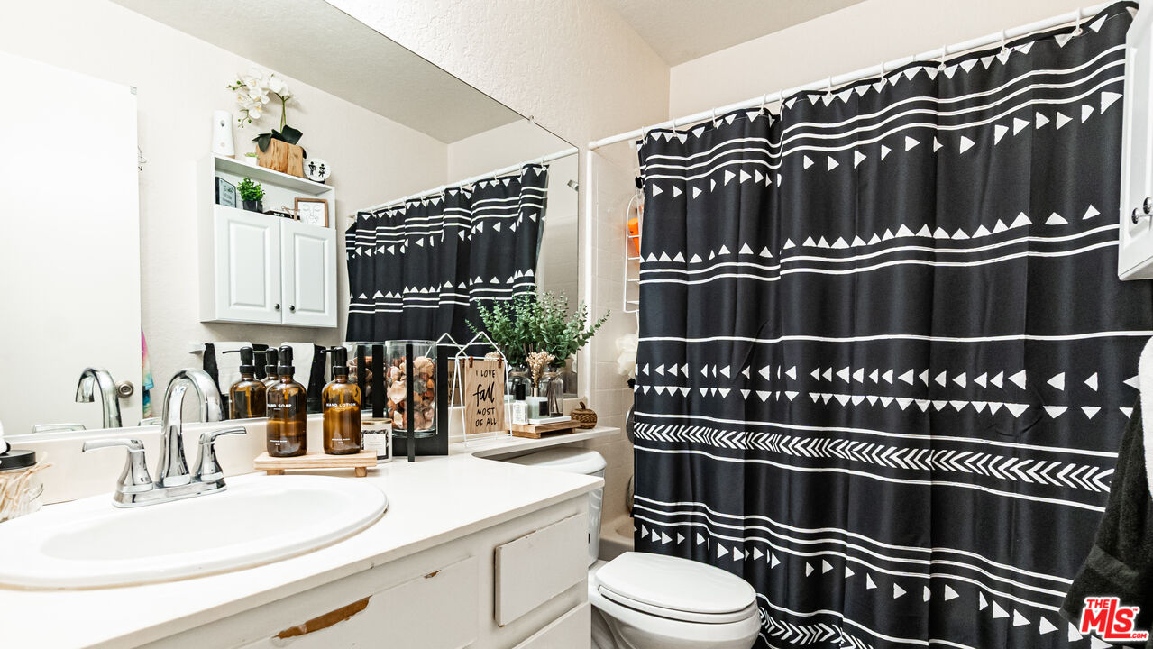 69817 Brookview Way Cathedral City, CA 92234 - Photo 15 of 38 a bathroom with a sink a mirror and a toilet