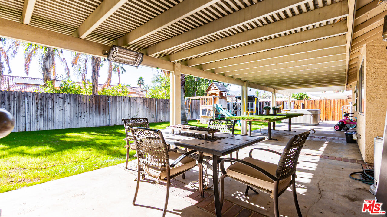 69817 Brookview Way Cathedral City, CA 92234 - Photo 25 of 38 a view of a patio with table and chairs with wooden floor