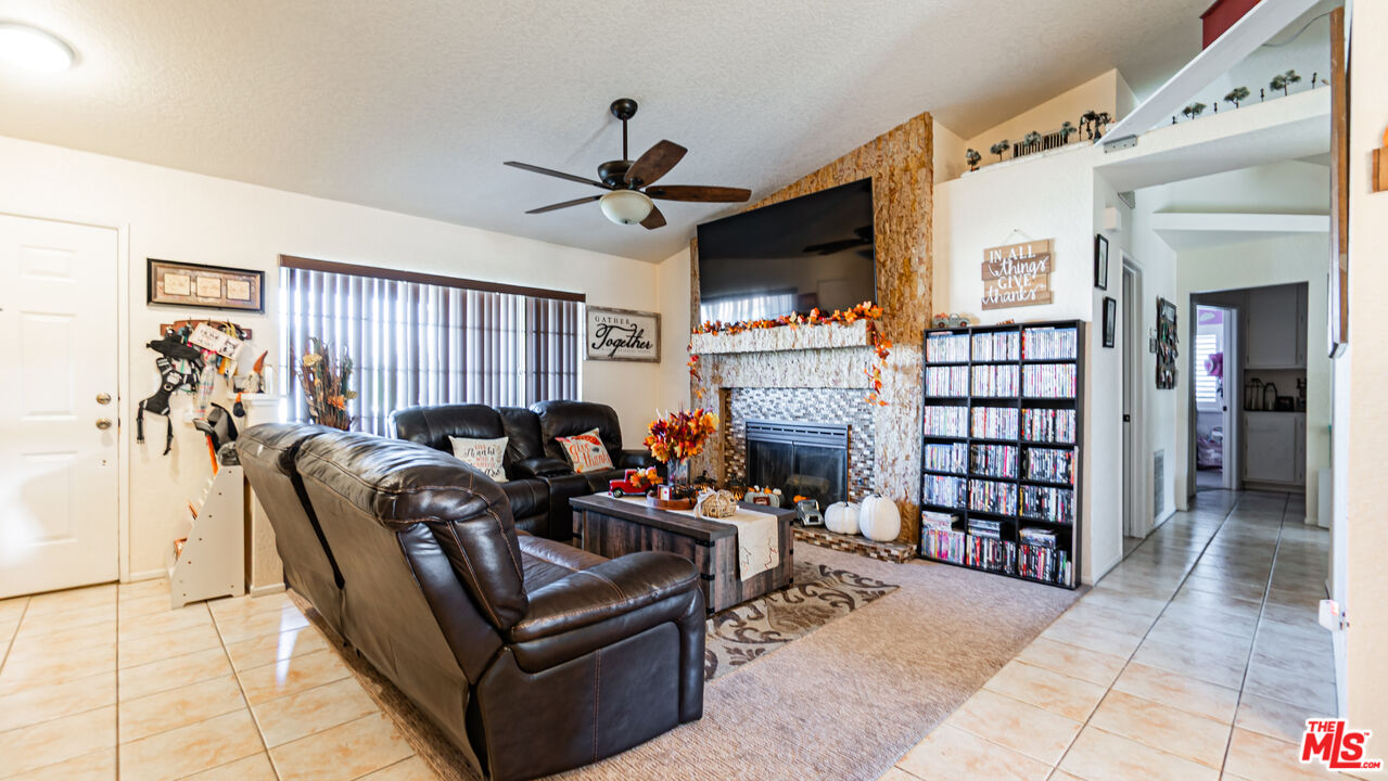 69817 Brookview Way Cathedral City, CA 92234 - Photo 3 of 38 a living room with furniture a ceiling fan and a rug