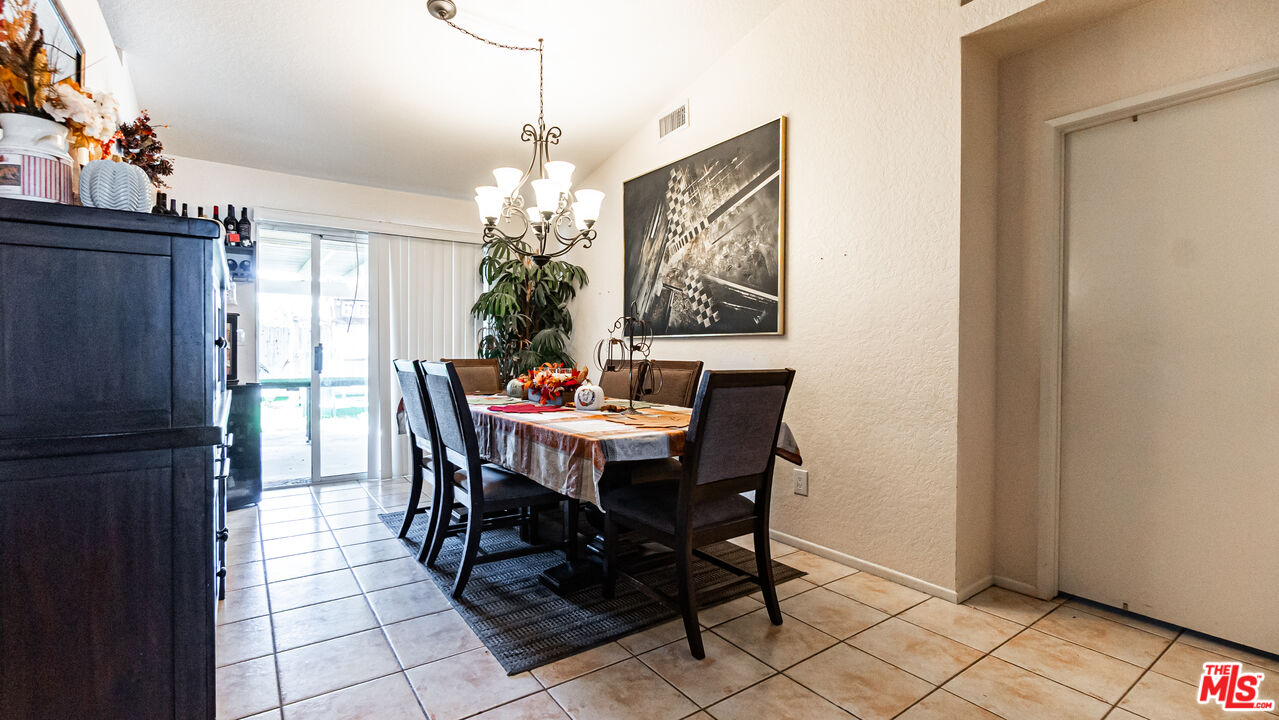 69817 Brookview Way Cathedral City, CA 92234 - Photo 5 of 38 a dining room with furniture a chandelier and window
