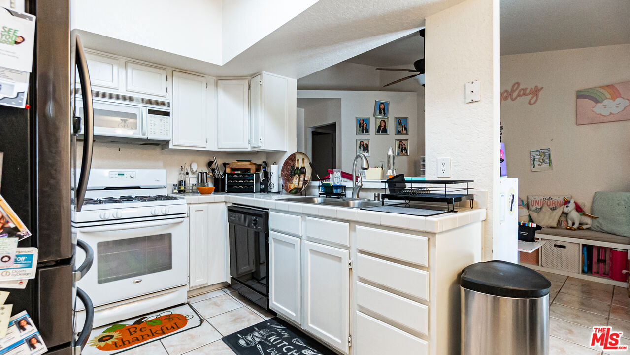 69817 Brookview Way Cathedral City, CA 92234 - Photo 9 of 38 a kitchen with stainless steel appliances granite countertop a sink and cabinets