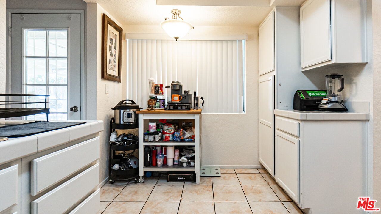 69817 Brookview Way Cathedral City, CA 92234 - Photo 10 of 38 a kitchen with stainless steel appliances a sink and a refrigerator