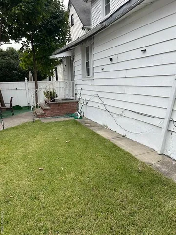 a view of a backyard with sitting area