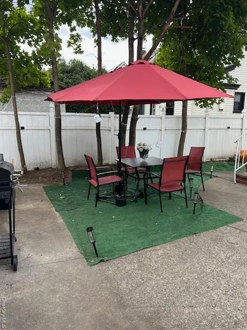 a view of a house with backyard and sitting area