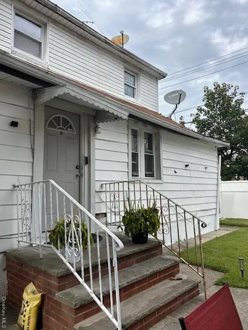 a view of a house with wooden floor and a fence