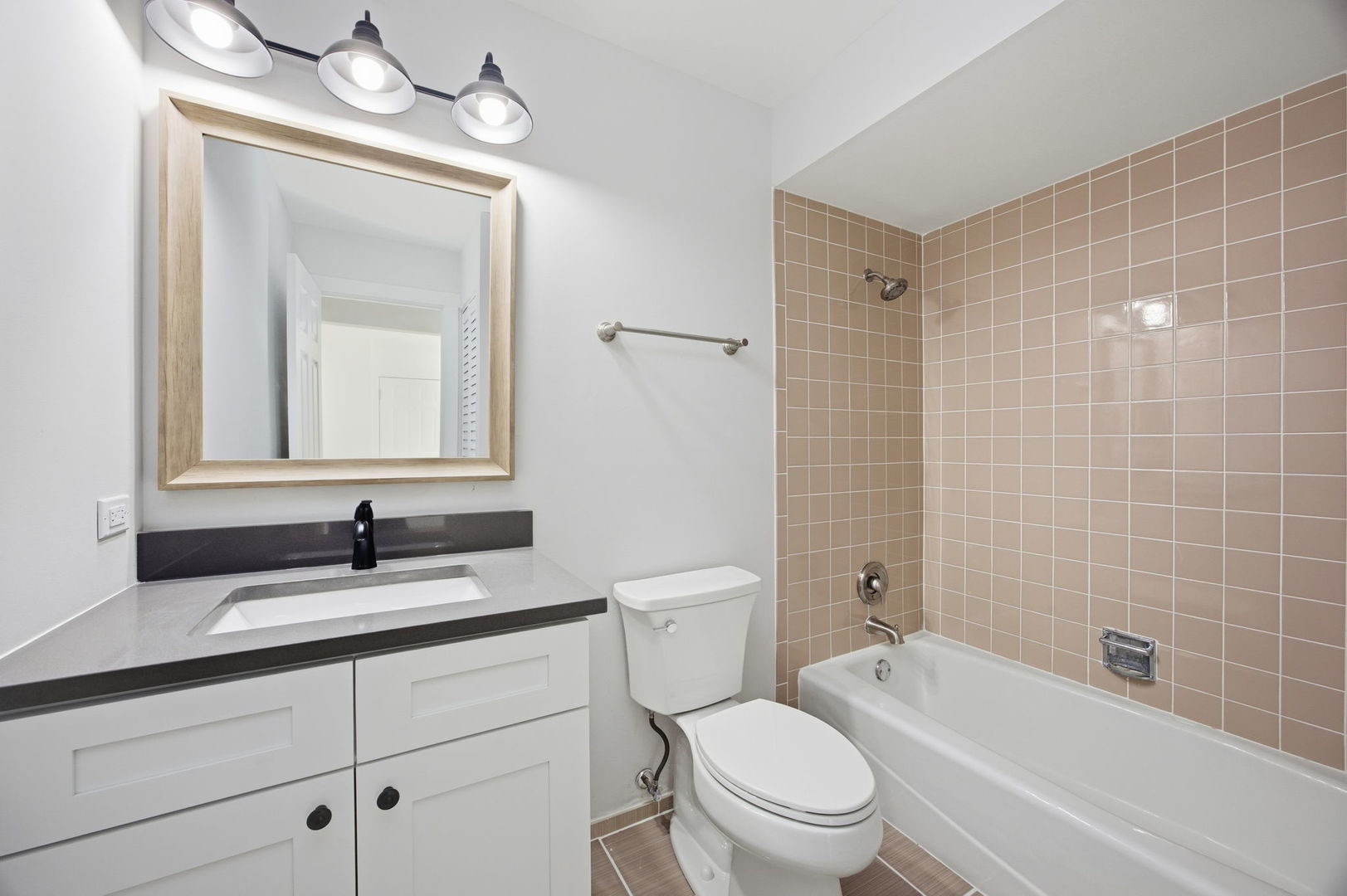 4654 West 131st Street, Unit 1S Alsip, IL 60803 - Photo 9 of 10 a bathroom with a granite countertop toilet a sink a mirror a bathtub and shower